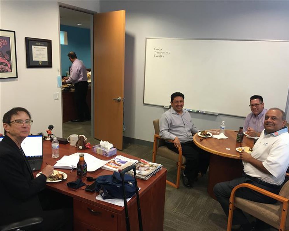 Employees gathered in an office meeting room during a team discussion