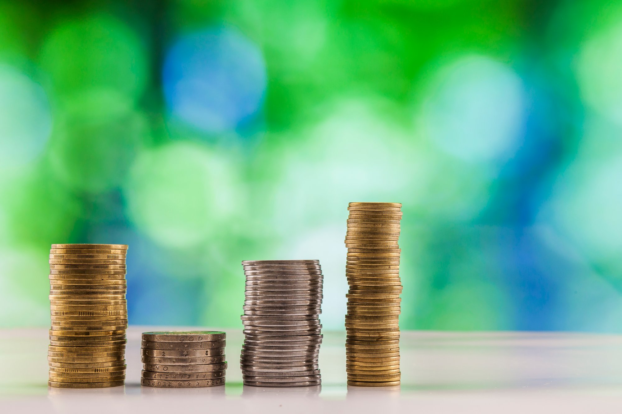 growing-coins-stacks-with-green-and-blue-sparkling-2026-01-06-10-00-00-utc